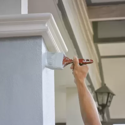 Man,Hand,Painted,A,House,Pillar,With,Brush
